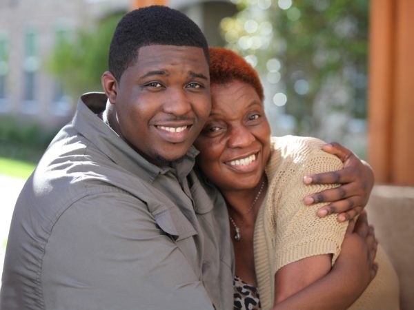 Man hugging his mom and smiling