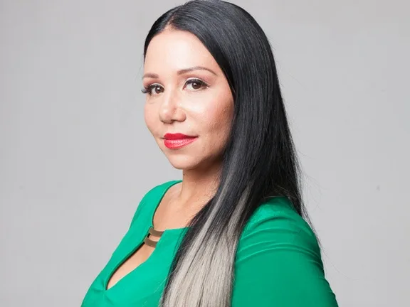 Woman with black hair smiling turned sideways