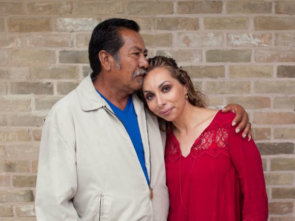 Man kissing woman's forehead