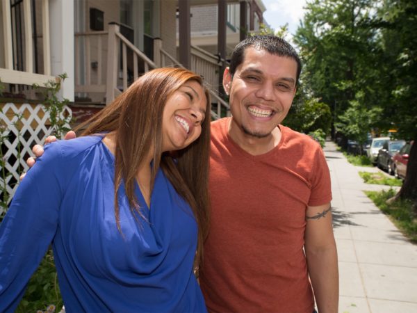 A man and woman smiling outside