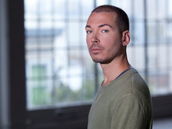 Young man with straight face looking at the camera