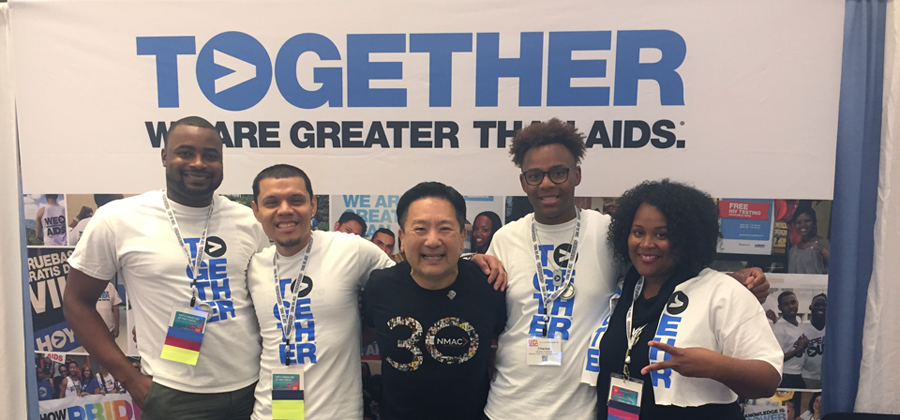 Men and women at Greater Than HIV #2019USCA! with branded "TOGETHER" t-shirts