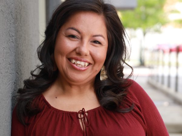 Woman smiling at camera outside