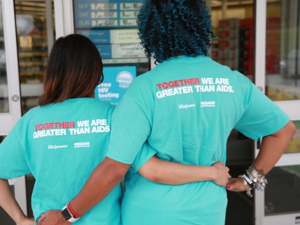 Two women in Greater Than HIV shirts